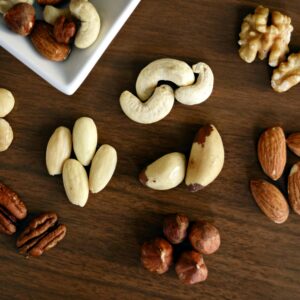 Variety of Brown Nuts on Brown Wooden Panel High-angle Photo